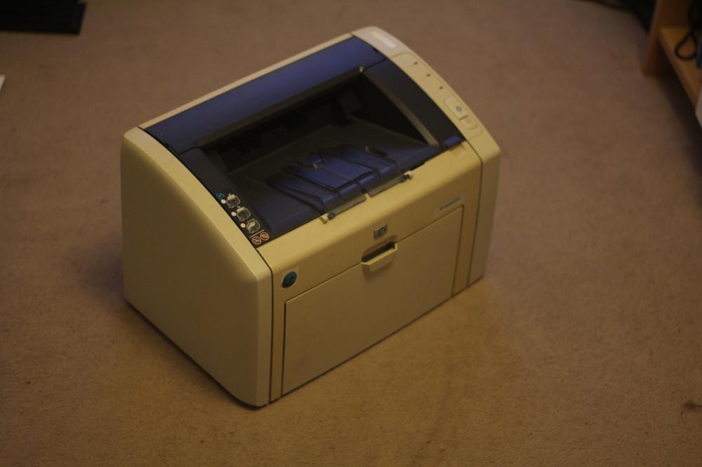 Old bulky beige printerNewer HL-1110 in the network corner